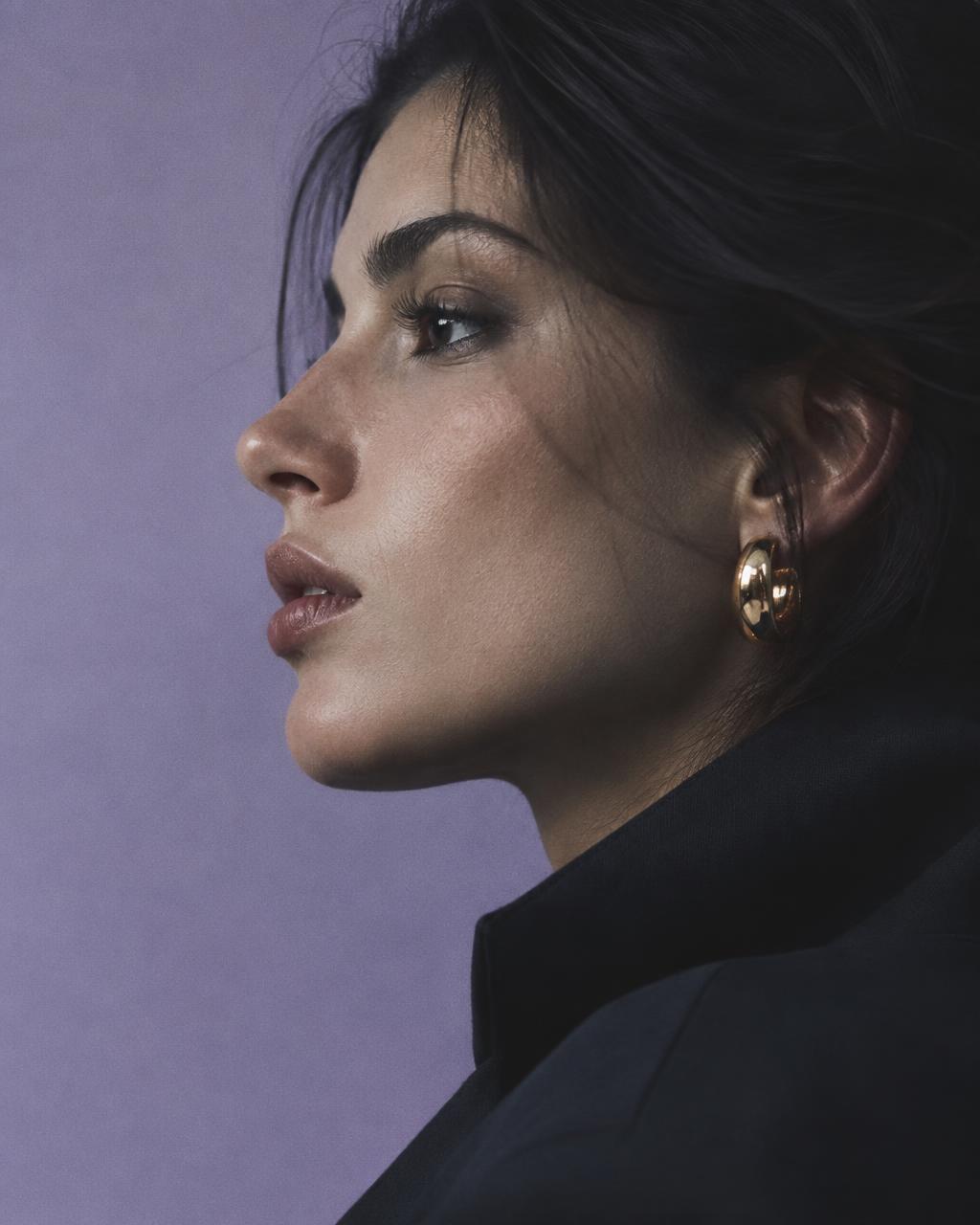 Close-up portrait in soft light against a lilac backdrop